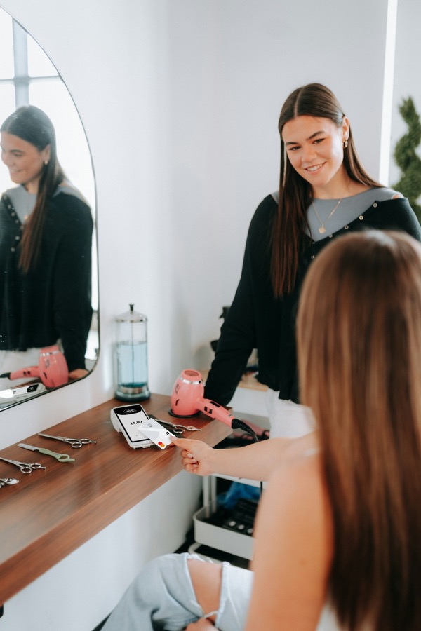Customer paying by card in a salon