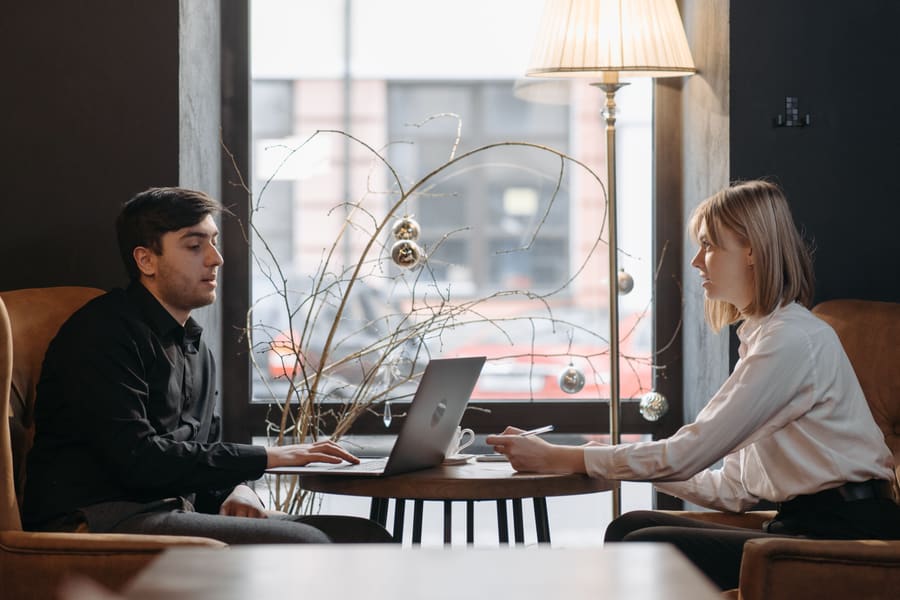 Two people reviewing a business website together on a laptop